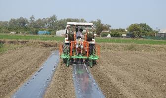 Tractor operated drip lateral and plastic mulch layer cum-planter2